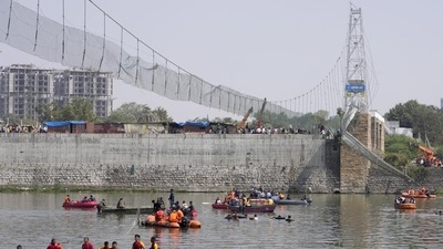 Rescuers in boats search the Machchu river next to the bridge that collapsed in Morbi. (AP) Rescuers in boats search the Machchu river next to the bridge that collapsed in Morbi. (AP)