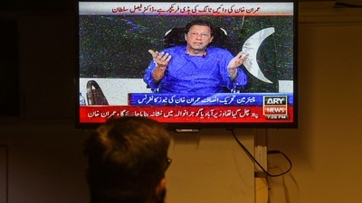 A man watches a television channel broadcasting the address of Pakistan former prime minister Imran Khan a day after an assassination attempt during his long march near Wazirabad, in Karachi on November 4, 2022. (AFP) A man watches a television channel broadcasting the address of Pakistan former prime minister Imran Khan a day after an assassination attempt during his long march near Wazirabad, in Karachi on November 4, 2022. (AFP)