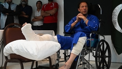 Pakistan's former prime minister Imran Khan interacts with the media at a Lahore hospital on Friday. (AFP)