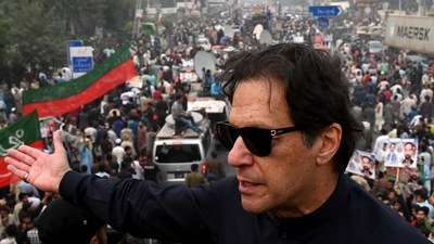In this photograph taken on November 1, 2022, Pakistan's former prime minister Imran Khan speaks while taking part in an anti-government march in Gujranwala. - Khan was shot in the foot at a political rally on November 3, 2022 but he is in a stable condition, an aide said. (Photo by Arif ALI / AFP) (AFP) In this photograph taken on November 1, 2022, Pakistan's former prime minister Imran Khan speaks while taking part in an anti-government march in Gujranwala. - Khan was shot in the foot at a political rally on November 3, 2022 but he is in a stable condition, an aide said. (Photo by Arif ALI / AFP) (AFP)