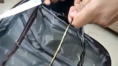 A video shared by the customs department shows the outer lining of the bag being cut open to reveal what seems to be an ordinary metal ring. (Chennai customs/ Twitter)