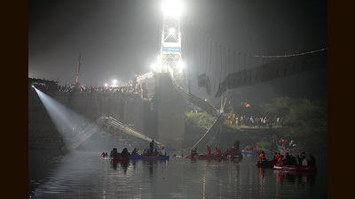 Officials carry out a search and rescue operation in Machchu river, on October 31. A suspension bridge in Gujarat’s Morbi collapsed on Sunday, killing 135 people. (AP) Officials carry out a search and rescue operation in Machchu river, on October 31. A suspension bridge in Gujarat’s Morbi collapsed on Sunday, killing 135 people. (AP)
