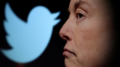 Twitter logo and a photo of Elon Musk are displayed through magnifier in this illustration. (Reuters)