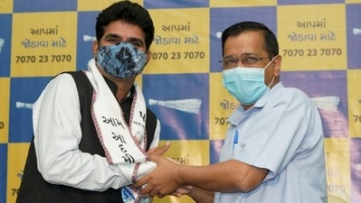 Gujarat's senior journalist Isudan Gadhvi with AAP convener and Delhi CM Arvind Kejriwal. (PTI file) Gujarat's senior journalist Isudan Gadhvi with AAP convener and Delhi CM Arvind Kejriwal. (PTI file)