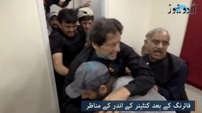 Former Pakistani Prime Minister Imran Khan is helped after he was shot in the shin in Wazirabad, Pakistan on Thursday. (Urdu Media via REUTERS)