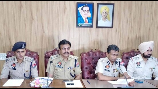 Police commissioner Kaustubh Sharma (third from left) and other police officers discussing the drug racket bust on Friday. (HT Photo)