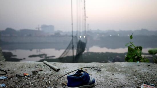 A shoe lies near a damaged suspension bridge after it collapsed on Sunday, in Morbi town in the western state of Gujarat (Reuters File Photo)