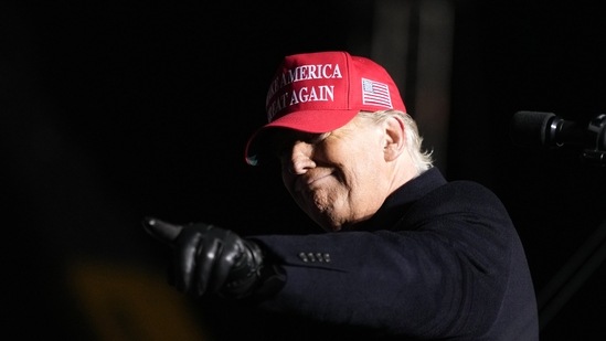 Former President Donald Trump reacts to a supporter during a rally, Thursday. (AP)