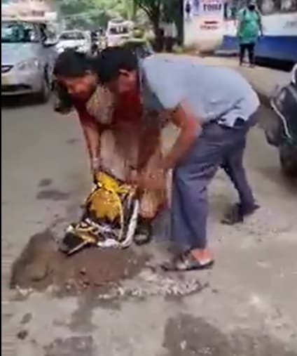 The couple was seen filling up a pothole after the husband went through a 'near-death' accident but escaped unhurt. (Screengrab of Twitter video-@SpeakUpBengalur) The couple was seen filling up a pothole after the husband went through a 'near-death' accident but escaped unhurt. (Screengrab of Twitter video-@SpeakUpBengalur)