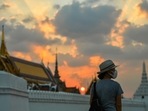 A tourist stands near the Grand Palace in Bangkok, Thailand, during sunset. (REUTERS/Chalinee Thirasupa)
