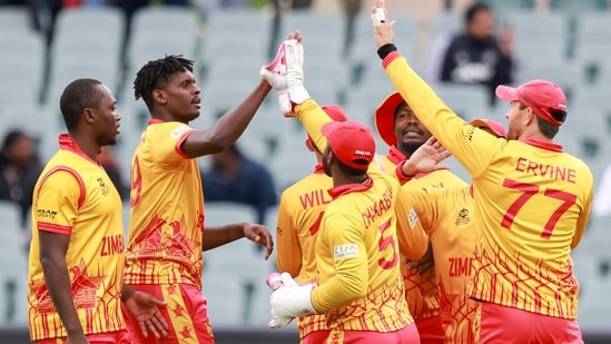 Zimbabwe players celebrate the dismissal of Netherlands' Colin Ackermann during the T20 World Cup cricket match between the Netherlands and Zimbabwe in Adelaide.(AP)