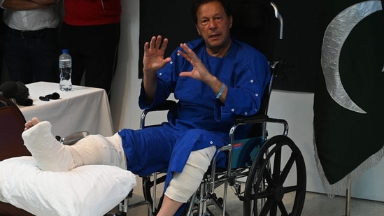 Imran Khan talks with media representatives at a hospital in Lahore on November 4, 2022, a day after an assassination attempt on him during his long march near Wazirabad. (AFP)