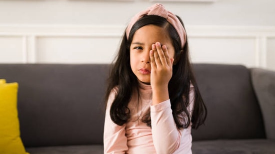 Tilting head or covering one eye: This might indicate that your child has a lazy eye or eyes are misaligned. It can also be the indication of Amblyopia which is the loss of the ability to see clearly through one eye.(istockphoto)