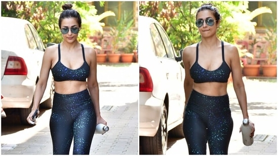 Malaika Arora stuns in a black printed sports bra and yoga pants outside yoga studio. (HT Photo/Varinder Chawla)