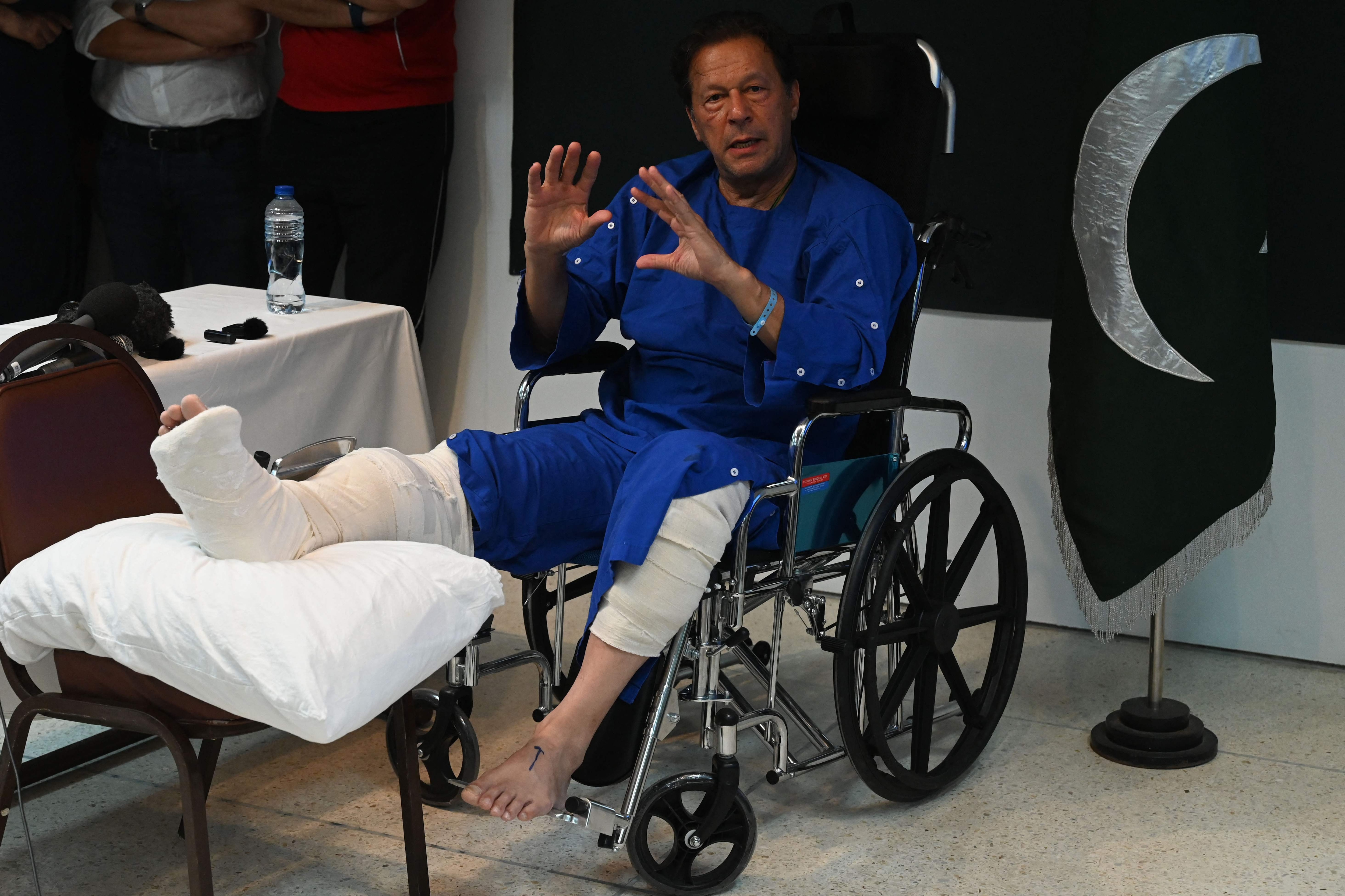 Imran Khan talks with media representatives at a hospital in Lahore on November 4, 2022, a day after an assassination attempt on him during his long march near Wazirabad. (AFP) Imran Khan talks with media representatives at a hospital in Lahore on November 4, 2022, a day after an assassination attempt on him during his long march near Wazirabad. (AFP)