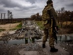Russia-Ukraine War: A Ukrainian serviceman stands at destroyed bridge near the Ukrainian border with Russia.