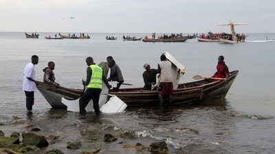 Rescuers carry debris as they search for survivors after a Precision Air flight that was carrying 43 people plunged into Lake Victoria as it attempted to land in the lakeside town of Bukoba, Tanzania on November 6, 2022. (AFP) Rescuers carry debris as they search for survivors after a Precision Air flight that was carrying 43 people plunged into Lake Victoria as it attempted to land in the lakeside town of Bukoba, Tanzania on November 6, 2022. (AFP)