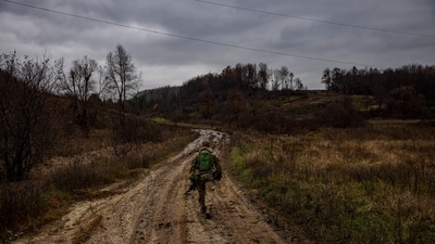 Russia-Ukraine War: A Ukrainian serviceman walks down a road near the Ukrainian border with Russia in Kharkiv region. (AFP) Russia-Ukraine War: A Ukrainian serviceman walks down a road near the Ukrainian border with Russia in Kharkiv region. (AFP)