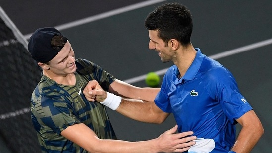 Denmark's Holger Rune (L) is congratulated by Serbia's Novak Djokovic after winning his men's singles final tennis match against Serbia's Novak Djokovic