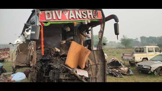 The damaged private sleeper bus on Yamuna Express Way in Agra on Sunday. (HT Photo)