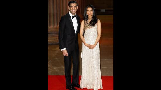 Defining elegance, Rishi opted for a sleek black tuxedo while Akshata opted for a white embellished gown (via Twitter).