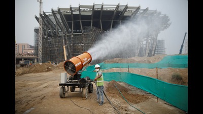 A worker operates an anti-smog gun at a construction site in New Delhi, India, October 14, 2020. REUTERS/Adnan Abidi (REUTERS)