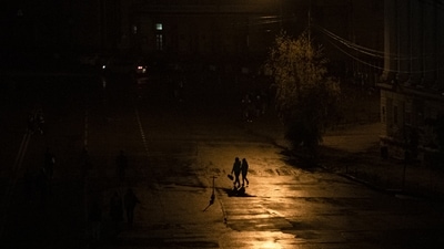 Russia-Ukraine War: People walk across a street during a blackout in Kyiv, Ukraine. (AP)