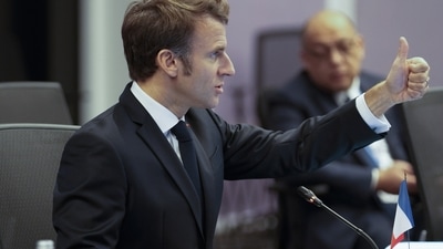 French President Emmanuel Macron thumbs up during a meeting at the COP27 summit. (AP)