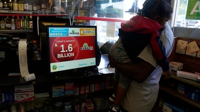 US Powerball Jackpot: A man buys lottery tickets ahead of the Powerball jackpot drawing. (AP)