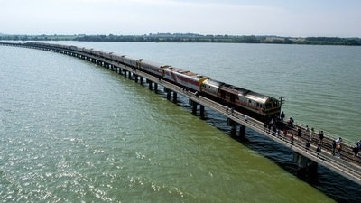 Thailand: Tourists enjoy after a train stops at the middle of Pasak Jolasid Dam in Lopburi province, Thailand. (Reuters)