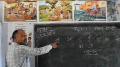 The image, taken from the Twitter video, shows the teacher teaching Hindi alphabets using a special song. (Twitter/@Ankitydv92)