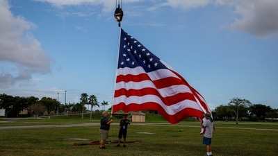 US Midterm Elections 2022: An American flag is raised prior to a "Save America" rally. (AFP) US Midterm Elections 2022: An American flag is raised prior to a "Save America" rally. (AFP)