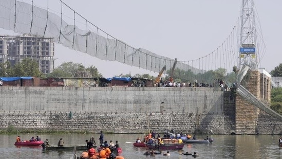 Rescuers in boats search the Machchu river next to the bridge that collapsed in Morbi. (AP)