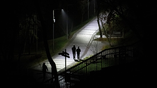 Russia-Ukraine War: People walk in a park during a blackout in Kyiv, Ukraine.(AP)