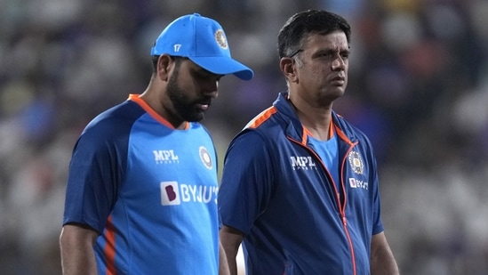 India's head coach Rahul Dravid, right, and captain Rohit Sharma walk in the field before the start of the second T20 cricket match between India and Australia(AP)