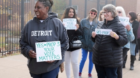 US Midterm Elections: Abortion rights activist holds a sign while waiting in line.(Reuters)