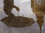 A woman with an umbrella and the Elizabeth Tower also known as Big Ben are reflected in a puddle in London.(AP) A woman with an umbrella and the Elizabeth Tower also known as Big Ben are reflected in a puddle in London.(AP)