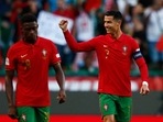 Portugal's Cristiano Ronaldo celebrates scoring a goal with Nuno Mendes.