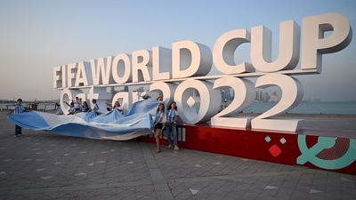 Argentina fans cheer in front of a FIFA World Cup sign in Doha (AFP) Argentina fans cheer in front of a FIFA World Cup sign in Doha (AFP)
