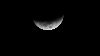The moon is seen during a total lunar eclipse in Villa Nueva, Guatemala on November 8. Binoculars and telescopes will enhance viewing, provided the skies are clear. (AFP)