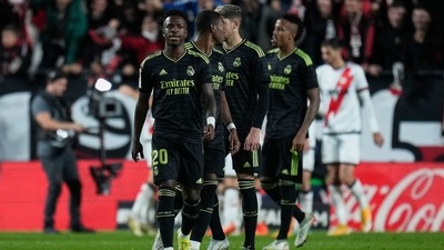 Real Madrid players, front, walk along the pitch as Rayo players celebrate their side's third goal during the Spanish La Liga soccer match between Rayo Vallecano and Real Madrid at the Vallecas stadium in Madrid (AP) Real Madrid players, front, walk along the pitch as Rayo players celebrate their side's third goal during the Spanish La Liga soccer match between Rayo Vallecano and Real Madrid at the Vallecas stadium in Madrid (AP)