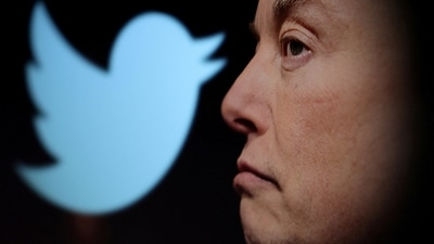 US Midterm Elections 2022: Twitter logo and a photo of Elon Musk are displayed through magnifier in this illustration. (Reuters)