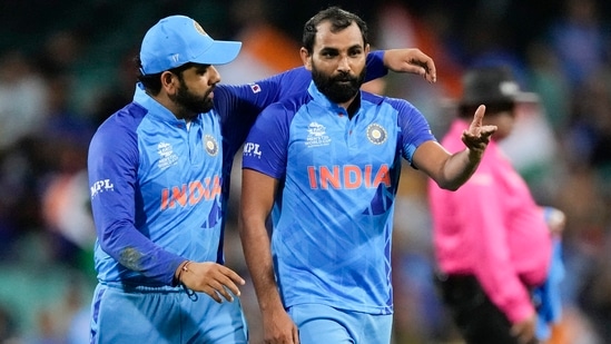 India's captain Rohit Sharma, left, talks with teammate Mohammed Shami during the T20 World Cup cricket match (AP)
