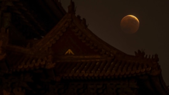 The world is witnessing the last total lunar eclipse of this year today, November 8. Totality will last nearly 1 1/2 hours from 5:16 a.m. to 6:41 a.m. EST as Earth passes directly between the moon and sun.(AP)