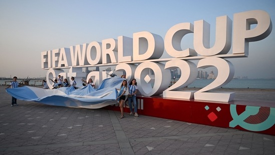 Argentina fans cheer in front of a FIFA World Cup sign in Doha(AFP)