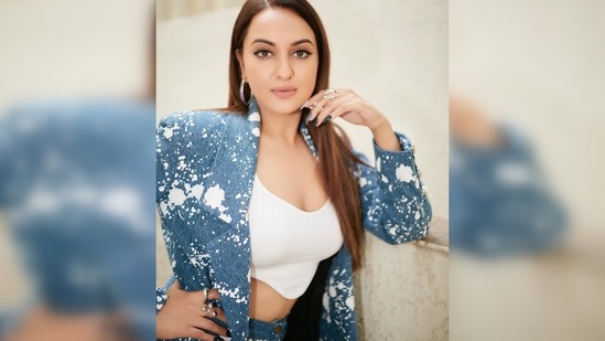 Sonakshi Sinha's look comprises an abstract printed denim pantsuit and a white crop top.(Instagram/@aslisona)