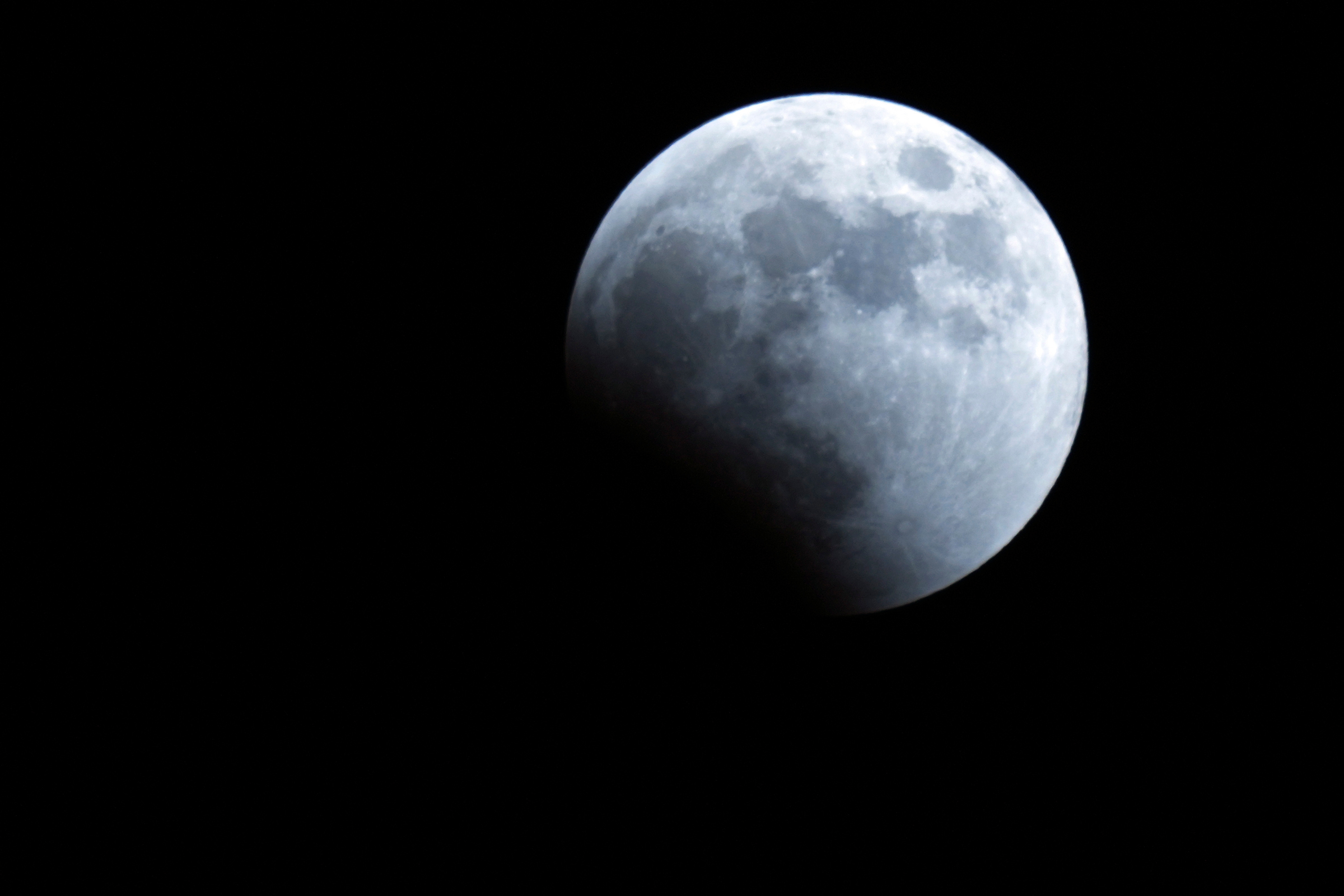 The Earth's shadow starts to cover the Moon during Lunar Eclipse in Tokyo. (AP) The Earth's shadow starts to cover the Moon during Lunar Eclipse in Tokyo. (AP)