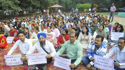 Teachers protesting at Sector 20 in Chandigarh on Wednesday. They expressed anger over the decision to arrest a teacher accused of sexually harassing a Class-7 student without conducting an inquiry into a complaint lodged under the POCSO Act. (Keshav Singh/Hindustan Times)