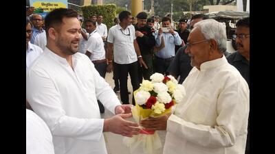 Bihar CM Nitish Kumar greets deputy CM Tejashwi Prasad Yadav on his 33rd birthday in Patna on Wednesday. (Santosh Kumar/HT Photo)