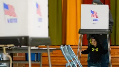 Jacob Lewis, 3, waits at a privacy booth as his grandfather, Robert Schroyer, fills out his ballot while voting at Sabillasville Elementary School. Jacob Lewis, 3, waits at a privacy booth as his grandfather, Robert Schroyer, fills out his ballot while voting at Sabillasville Elementary School.